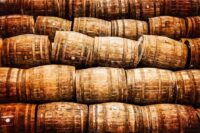 Stacked Pile Of Old Vintage Whisky And Wine Wooden Barrels