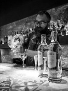 Mezcal Amores bottles and bartender pouring