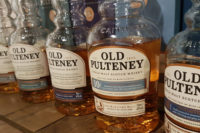 A row of Old Pulteney Scottish whisky bottles