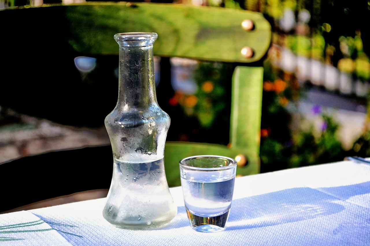 Glass of ouzo with a carafe of water