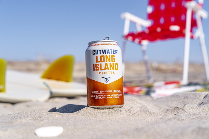 Cutwater Canned Cocktails Long Island Iced Tea can on beach