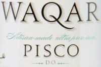 Detail from the label of a bottle of Pisco Waqar from Chile and made from Muscat grapes