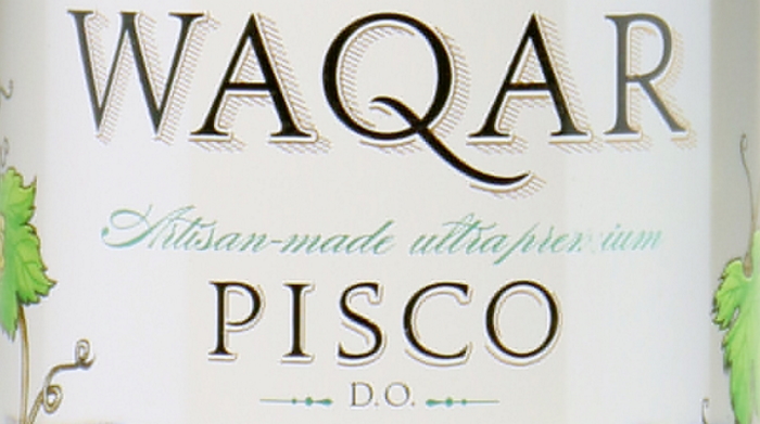Detail from the label of a bottle of Pisco Waqar from Chile and made from Muscat grapes