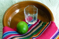 A tequila glass and a lime