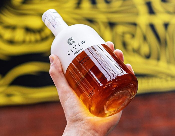 VIVIR Tequila Reposado bottle and hand