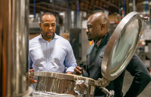 Duke and Dame Owners Amani and Chima in the Distillery