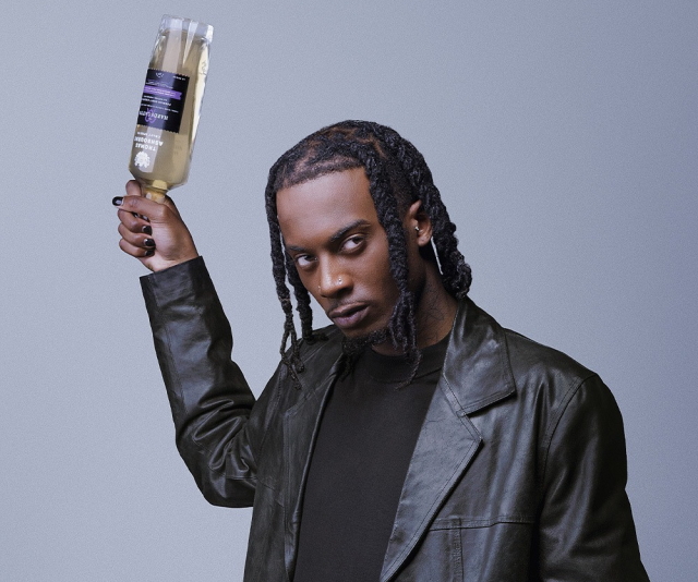 Playboi Carti olding a bottle of his Hardscatto cocktail