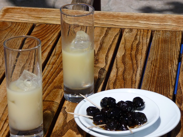 Two glasses of pastis and a plate of olives