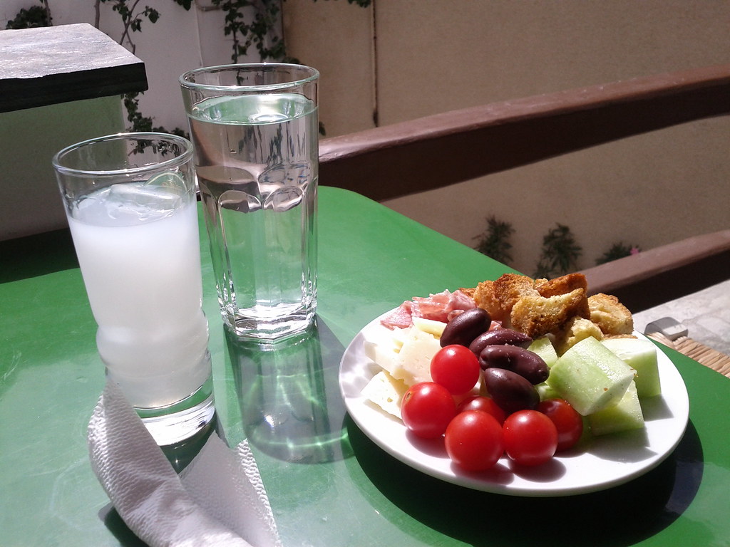 Glass of Ouzo Enjoyed with a Greek Salad