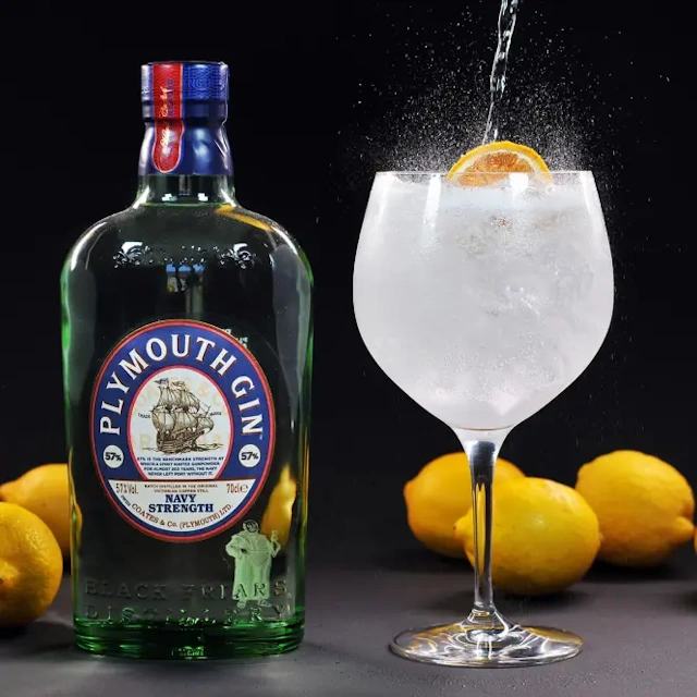 A bottle of Navy Strength Plymouth Gin with a glass of gin and tonic